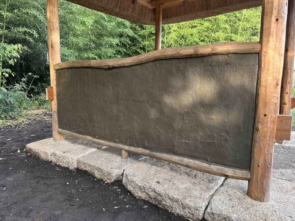 茅ヶ崎市の茅葺きの四阿施工中の様子で、荒壁塗りが終わった様子を外側から